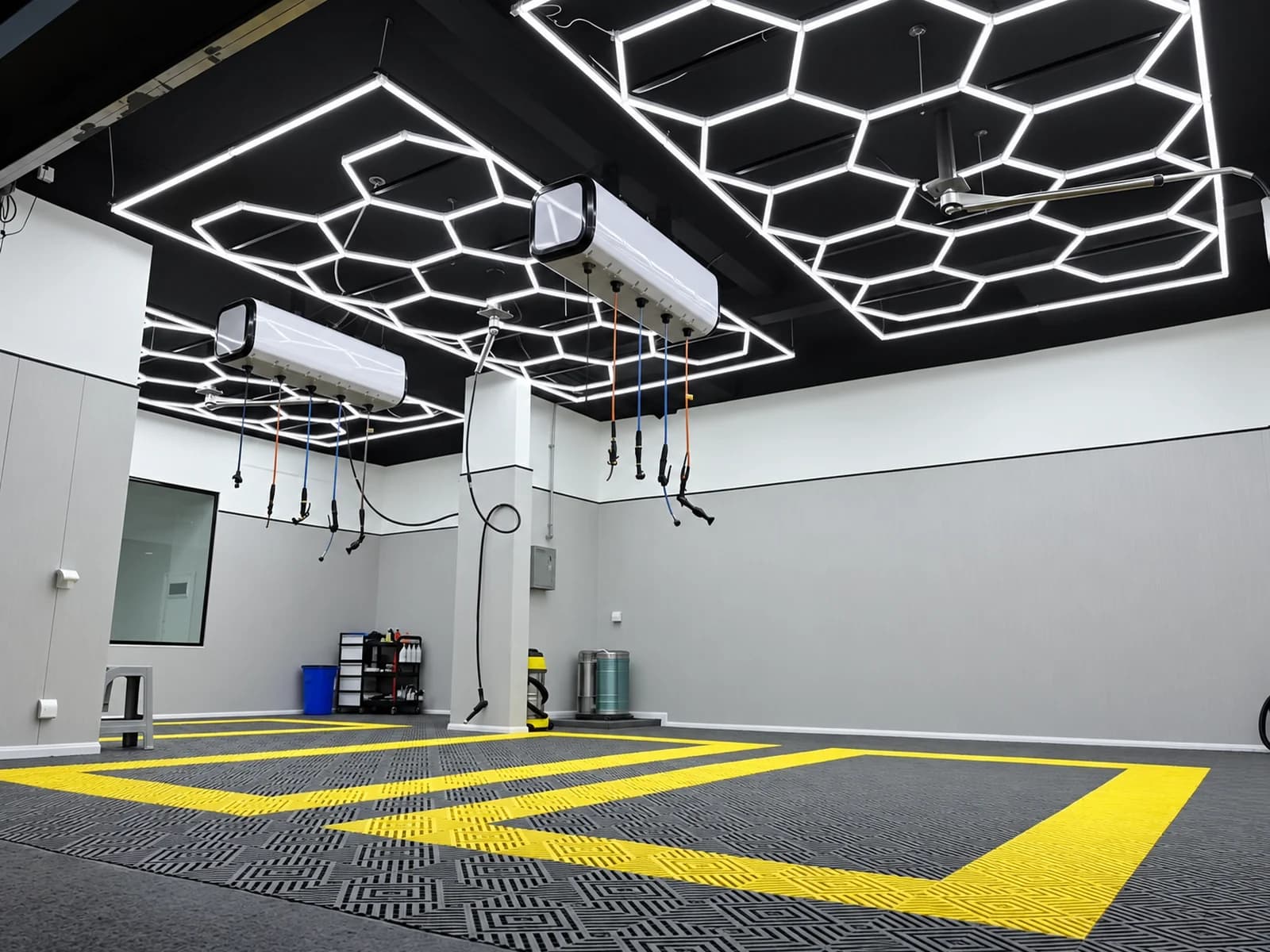 Two honeycomb LED ceiling layouts installed above automotive work bays
