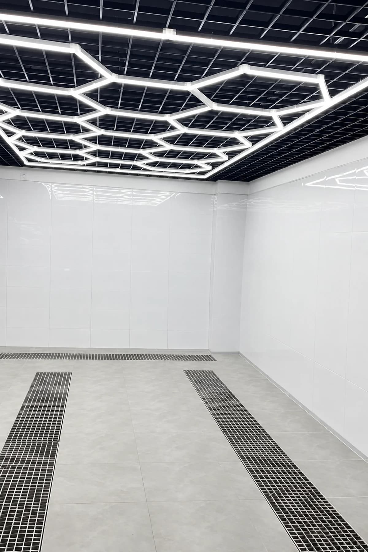 Full honeycomb LED ceiling grid installed in a clean automotive garage