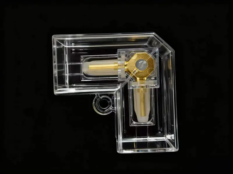 Clear L-shaped connector with brass contacts